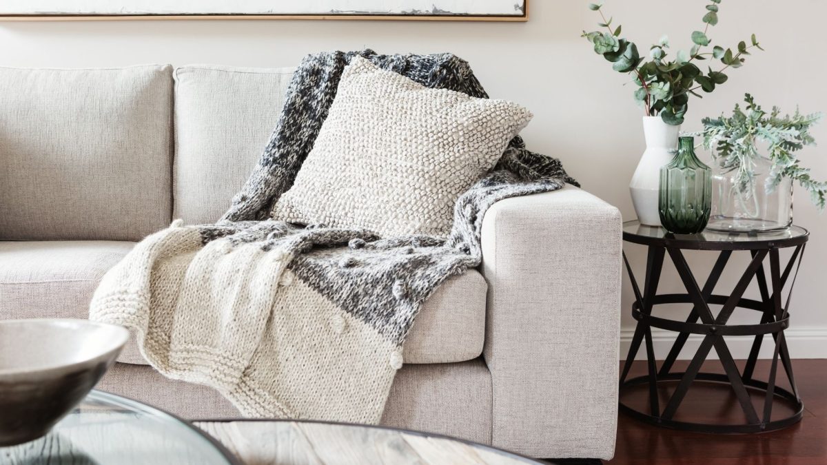 Image of a psychology clinic space in Melbourne, this includes a light beige couch and coffee table