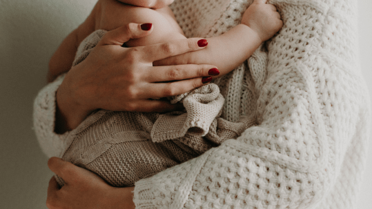 woman holding new born baby
