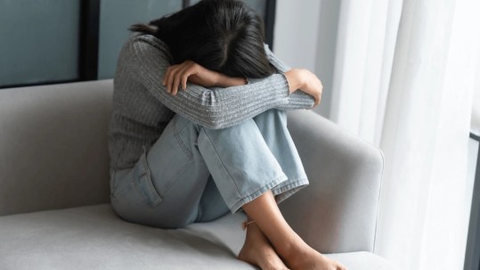 Positive Wellbeing Psychology Melbourne | Depression Psychiatrist Melbourne: Assessment & Treatment Options Adult sitting with a distressed expression, reflecting someone seeking support from depression psychiatrists for ongoing mood symptoms.
