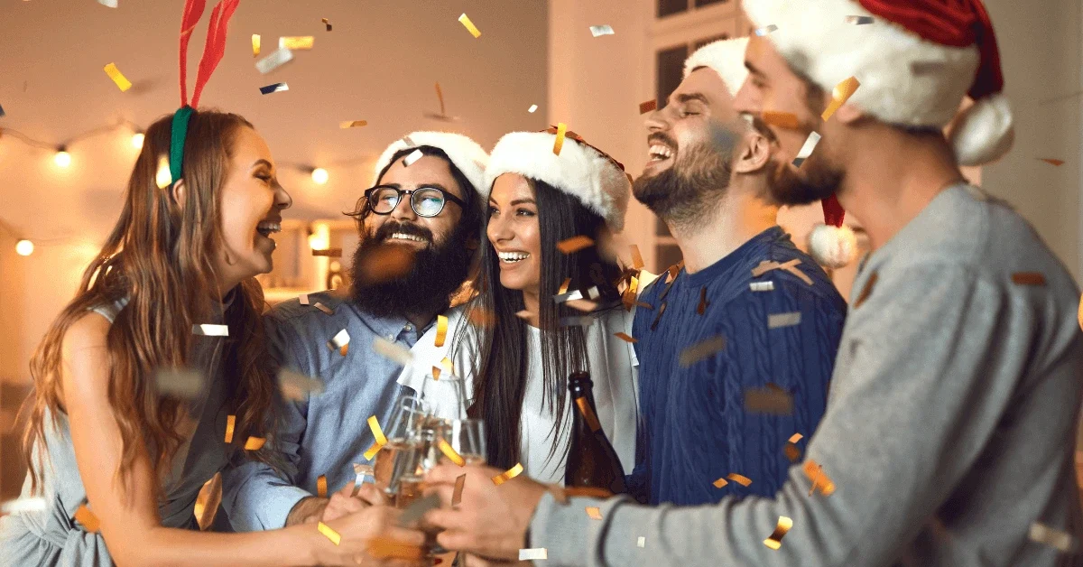 Friends celebrating Christmas together, showing how Christmas stress and stress at Christmas can appear even in joyful moments, with Xmas stress, holiday anxiety and anxiety during the holidays affecting social experiences.