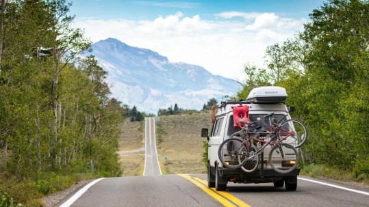 Positive Wellbeing Psychology Melbourne | Struggling to Adjust to a Big Life Change? Here's Why It's Harder Than You Think SUV driving on mountain road with bicycles