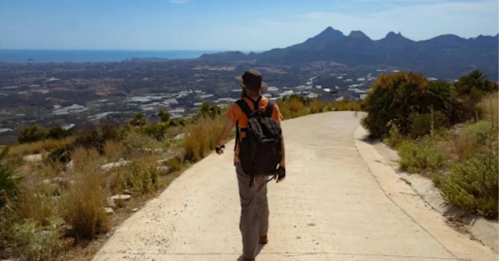 Positive Wellbeing Psychology Melbourne | Identity and Values: Feeling Stuck When You Don’t Know What You Want Hiker walking along a mountain trail with a backpack