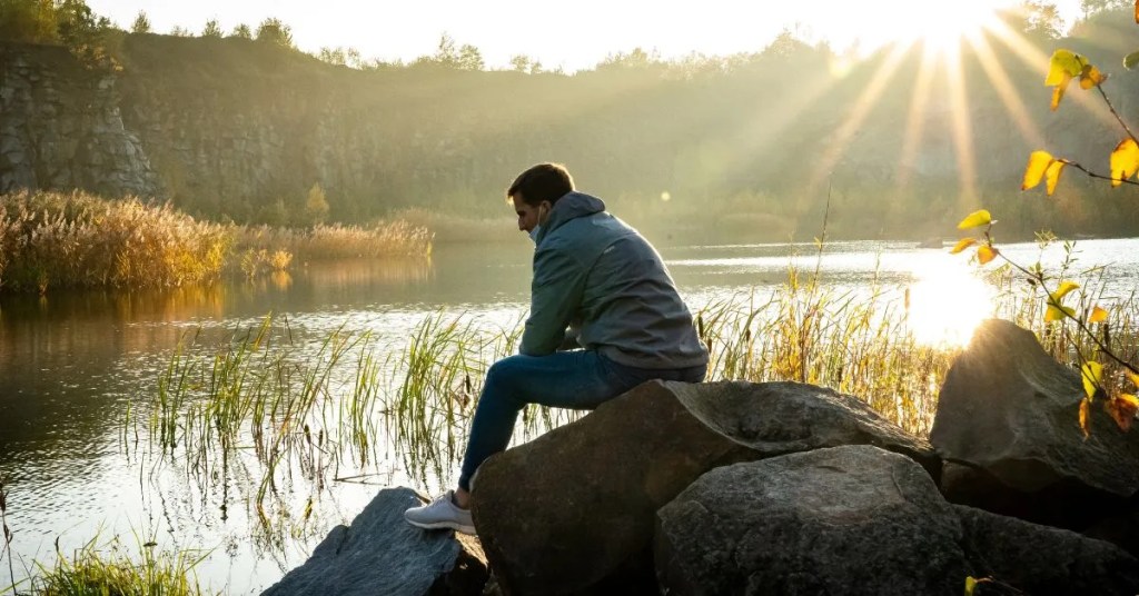 Positive Wellbeing Psychology Melbourne | When Depression Doesn't Respond to Treatment: Understanding Treatment-Resistant Depression Man sitting by lake at sunset
